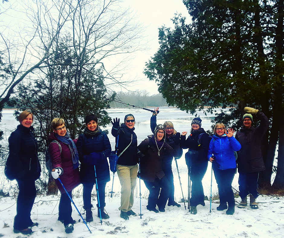 A group of smiling people standing in the snow