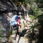 Jess climbing stone steps on a hiking trail